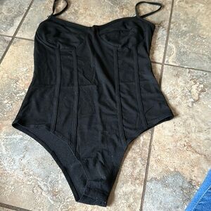 Form fitting body suit with clasps at bottom semi built in bra